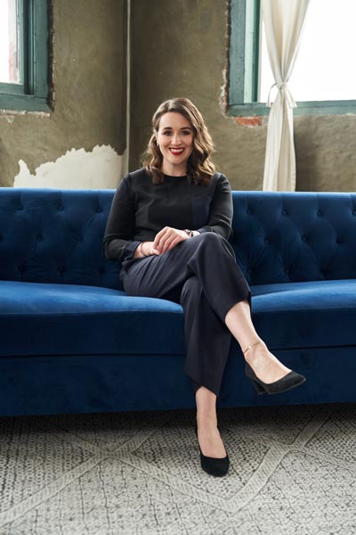 a woman sitting on a blue couch